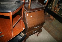 A SMALL BUREAU ON CABRIOLE LEGS