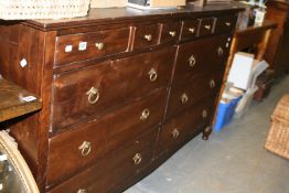A LARGE HARDWOOD CHEST OF DRAWERS