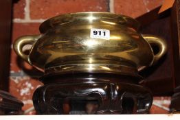 A CHINESE BRONZE CENSER WITH IMPRESSED SEAL TO BASE, ON CARVED HARDWOOD STAND.