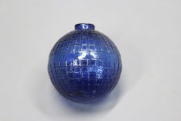 A dark blue glass target ball embossed with lattice work finish.