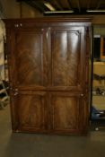 A William IV mahogany compactum wardrobe with two side hanging compartments, fitted slides and