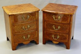 A pair of French kingwood parquetry inlaid bowfront small chests in Regence style, each with three