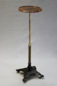 A Victorian cast iron and brass adjustable stand.