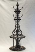 A Coalbrookdale cast iron hall stand, with five branch coat hangers above shaped stick stand with