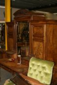 Gillows: a four piece walnut bedroom suite comprising a triple door wardrobe, dressing table and