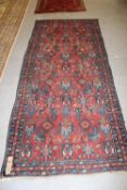 A Persian rug, 288 x 128cm.