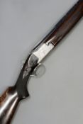 A double barrelled 12-bore O/U Browning B25 C4-2, 27.5inch sighted barrles, scroll engraved action