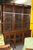 A Victorian mahogany glazed bookcase cabinet, in the late Aesthetic manner, the upper section with