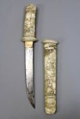 A Japanese ivory mounted tanto, 19.5cm double fullered blade, the ivory tsuka well carved with