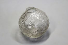 A white glass target ball embossed with a man shooting.