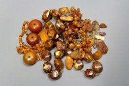 A collection of various strung and loose amber beads.