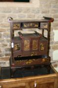 A 19th Century Japanese lacquer cabinet on stand, with numerous fitted compartments, some