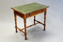 A 19th Century French faux bamboo writing table, the tooled green leather inset top above apron