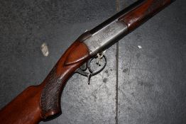 A single barrelled 12-bore sporting gun, the action decorated with a rabbit and stamped Made in