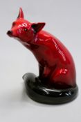 A Royal Doulton flambe glaze seated fox, 23.5cm high.