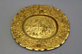 A Continental gilt metal oval repousse plaque in the Baroque style, the wide border of foliate