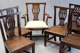 Six early 19th Century country made walnut dining chairs, comprising five plank seat side chairs and