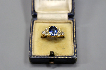 An 18ct gold sapphire and diamond set ring, (tested).