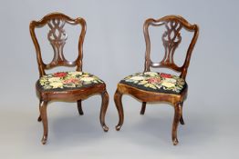 A pair of 19th Century Continental carved side chairs, each with pierced back panel and