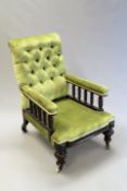 A large Victorian carved gentleman’s library armchair with button upholstery, swirl supports and