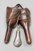 A pair of 19th Century French leather saddle holsters together with a planished tin powder flask.