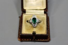 An Art Deco emerald and diamond set ring.