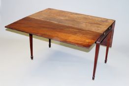 An early 19th Century mahogany pembroke table, with deep drop leaves and frieze drawer on square