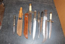 A large Bowie type knife, with faceted back edge and marked Wilkinson, London, composite hilt with