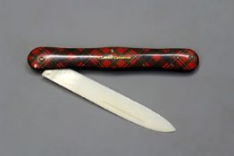 A tartanware pocket knife with ivory blade.