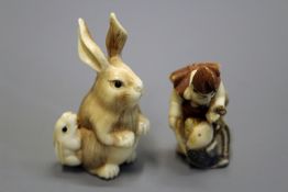 A Japanese Meiji ivory netsuke depicting a seated hare with leveret at its side, each with inset