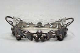 Jungenstil: an oval twin handled centrepiece with cut glass liner, the frame decorated with silvered