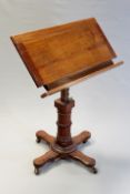 A Victorian mahogany adjustable reading stand on X form base.