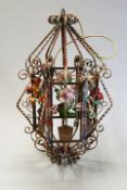 Six various wrought iron and polychrome decorated hanging hall lanterns, each approximately 85cm