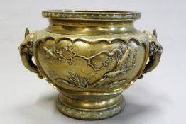 A 19th Century Japanese bronze jardiniere decorated with broad panels of birds and foliage within