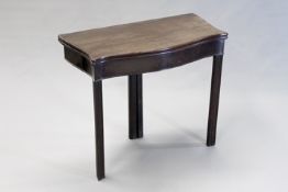 A George III carved mahogany tea table, the moulded edge top of serpentine form with swing leg