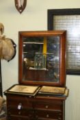 A 19th Century mahogany and inlaid cushion framed mirror, 84cm wide.