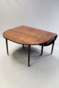 A large George III mahogany gateleg dining table, the oval top on six square section tapering legs