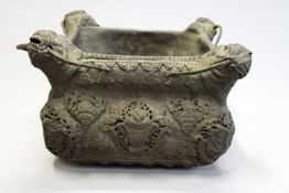 An Eastern square form bowl, possibly Tibetan with pierced and embossed copper decoration.