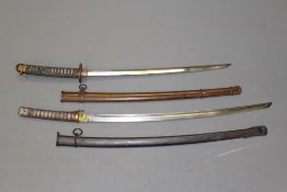 A Japanese Shin Gunto, 55,5cm blade, regulation brass mounts contained in its brown painted metal