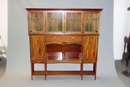 Liberty & Co: a mahogany side cabinet with lead glazed four door display cabinet above an