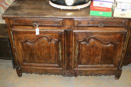 A French provincial carved oak cabinet, the moulded edge top above two frieze drawers, two