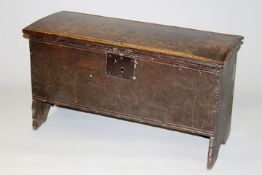 A 17th Century oak plank coffer of small size with chip carved decoration, 100cm wide.
