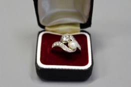 A French 18ct gold pearl and diamond set ring. (tested).