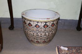 A Chinese large famille rose jardiniere with stylized flower head decoration on a black ground, 32cm