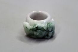 An Oriental jadeite ring with carved monkey decoration.