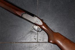 A double barrelled 12bore Rizzini Over and Under shotgun, 28inch barrels, scroll engraved