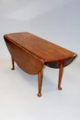 A bespoke George III style mahogany gateleg wake table on turned tapering legs and club feet,