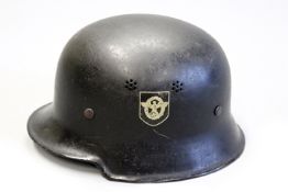 A Third Reich Police helmet, the black painted vented steel helmet with double decals, leather liner