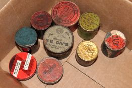 Nine various tins of percussion caps. (9)