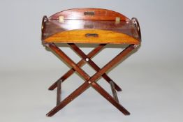 An early 19th Century mahogany butler’s tray, with folding sides and stand together with three